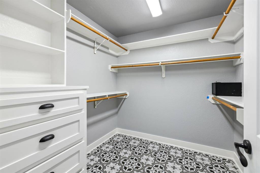 Large walk in closet with lots of storage space