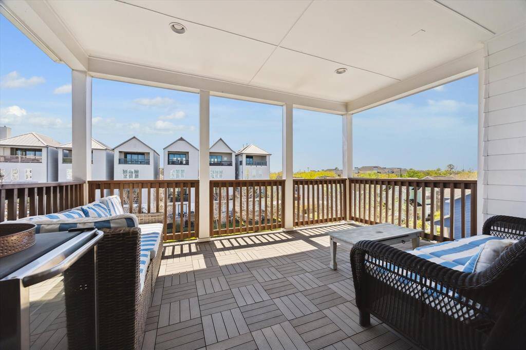 1240 West 16th ST overlooks a tranquil pond with a fountain, surrounded by a neatly landscaped area and a decorative iron fence, creating a peaceful and resort-like setting.