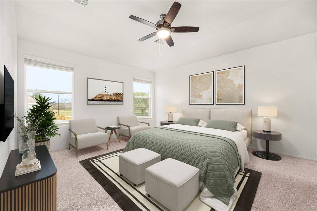 What a wonderful place to come home to, this stunning primary suite greets you with plush carpet floors, a warm neutral paint, raised ceilings, ceiling fan with lighting, lovely windows with blinds allowing in natural light brightening up this spacious primary bedroom, with extra space for a seating area.
