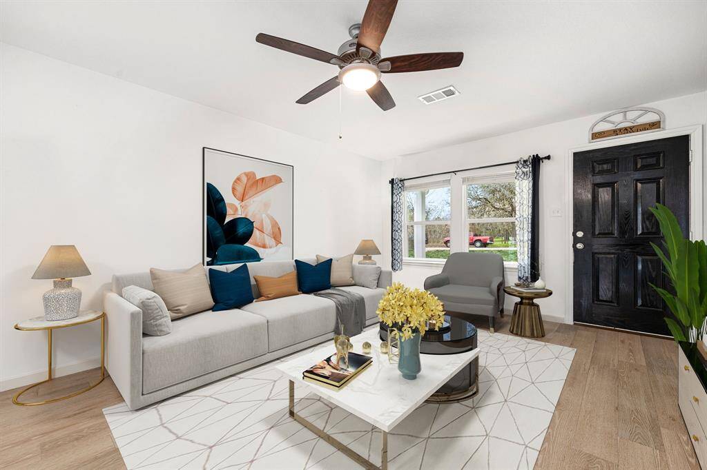Gather the family and guests together in your lovely living room! Featuring high ceiling, dark stained ceiling fan with lighting, neutral paint, gorgeous vinyl floors and large windows that provide plenty of natural lighting throughout the day.