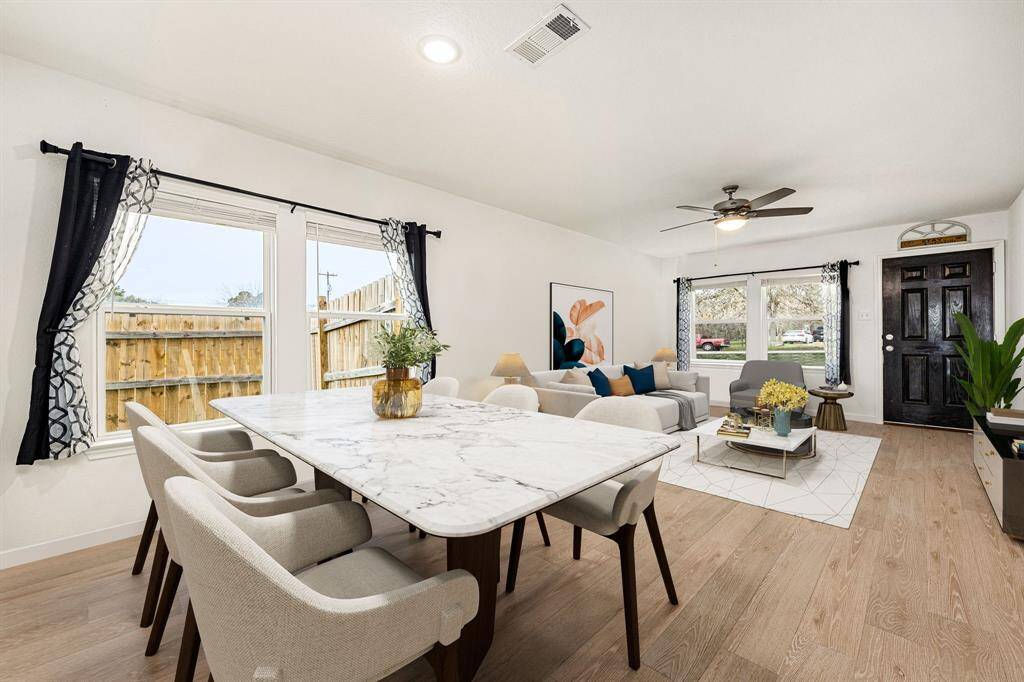 Step into this bright and inviting space, featuring large windows that fill the room with natural light and beautifully showcase the warm vinyl flooring. The open layout seamlessly connects the living and dining areas, creating a perfect flow for daily living and entertaining. The neutral palette enhances the sense of calm and provides a blank canvas for your personal style.