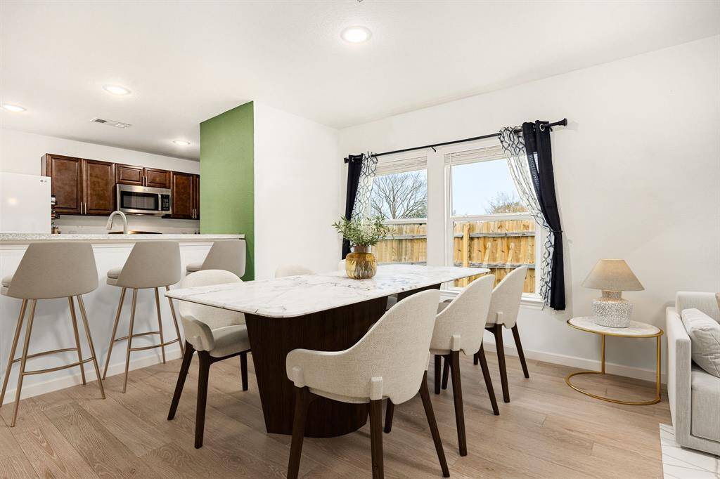 Make memories gathered around the table with your family and friends! This dining room features high ceilings, large windows, luxury vinyl floors and a easy access to the kitchen for seamless entertaining.