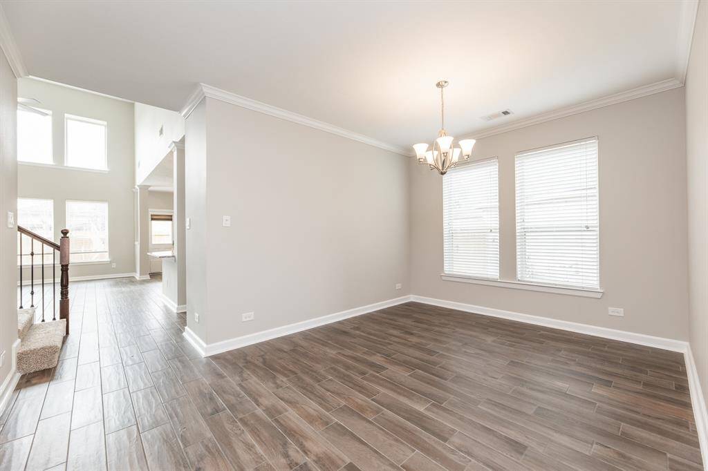 View from dining room looking at high ceiling living areas.