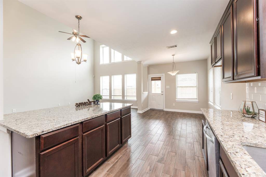 The kitchen boasts granite countertops and freshly painted cabinets.
