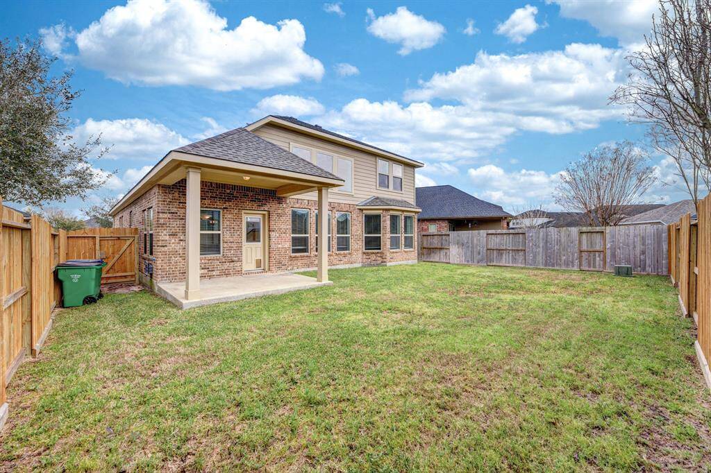 Covered patio with new backyard fence.