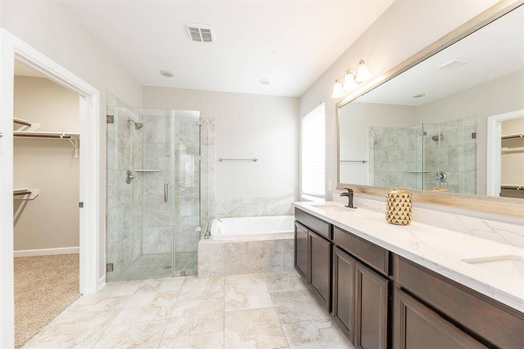 Primary bathroom features new countertops and dual vanities.