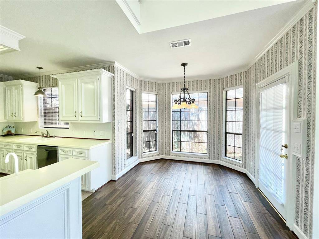 Breakfast area off the kitchen, with easy access to the covered patio. New porcelain tile and lots of natural light.