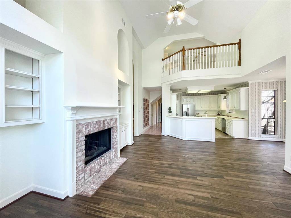 Living room looking straight on to the kitchen. Open area with 2 story ceilings.