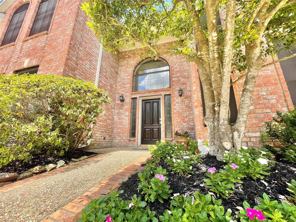 Walk right up to the grand entrance from a pebble stone and brick border walkway. Landscaping maintained by HOA.