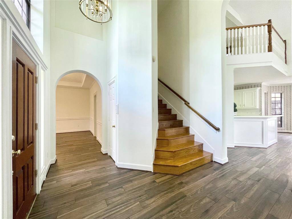 Views from the entry of the formal dining, stairs, balcony from game room, kitchen area.