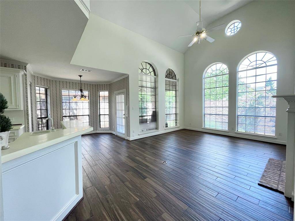 Living area and breakfast area. Breakfast bar opens up into the living room. Lots of natural light in this area and porcelain floors.