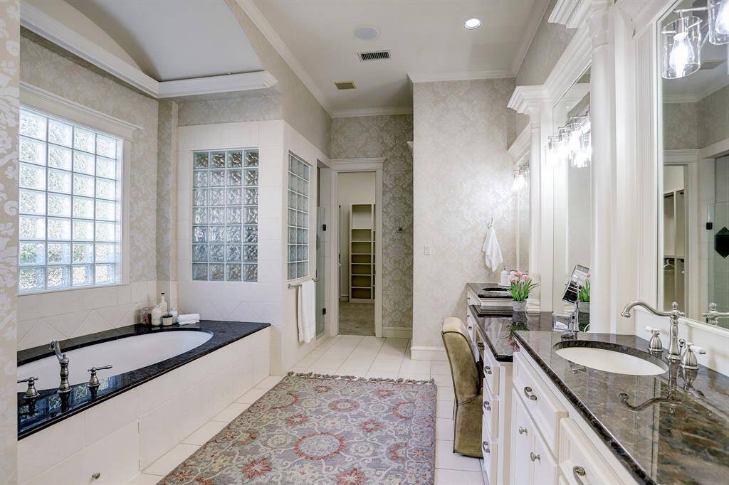 Primary Bath features double sinks, vanity, tub and separate shower.
