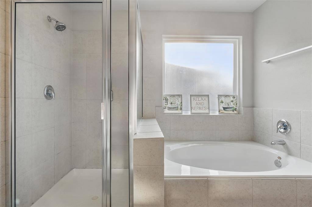 The walk-in shower has tile surround and the separate tub is great for soaking after a long day.