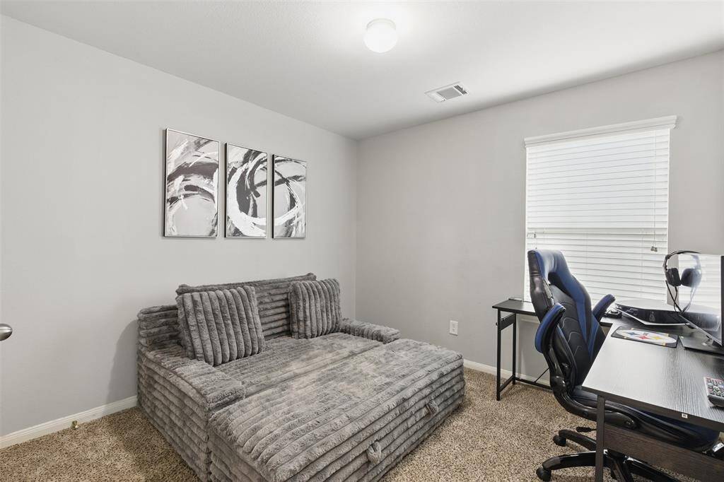 Third bedroom features awindow and plush carpet.