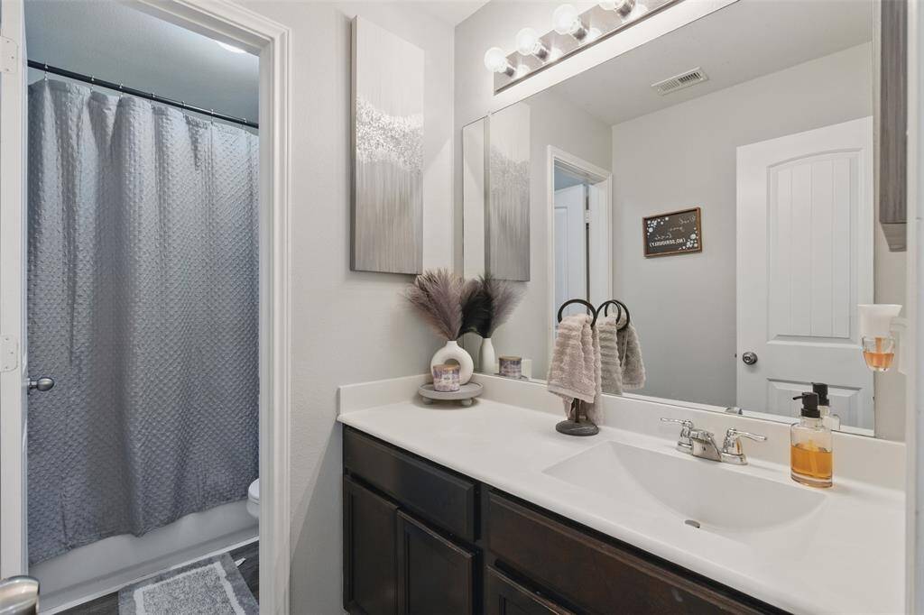 Secondary bathroom features atub/shower combo and long vanitywith plenty of counter space.