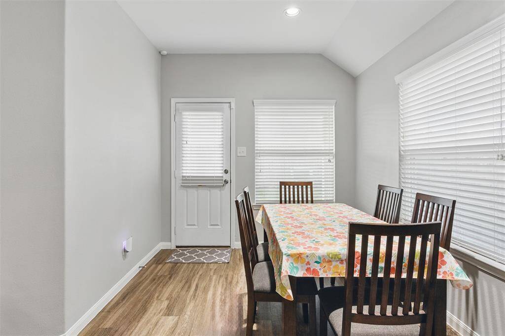 This dining room is bathed in naturallight streaming through expansivewindows.
