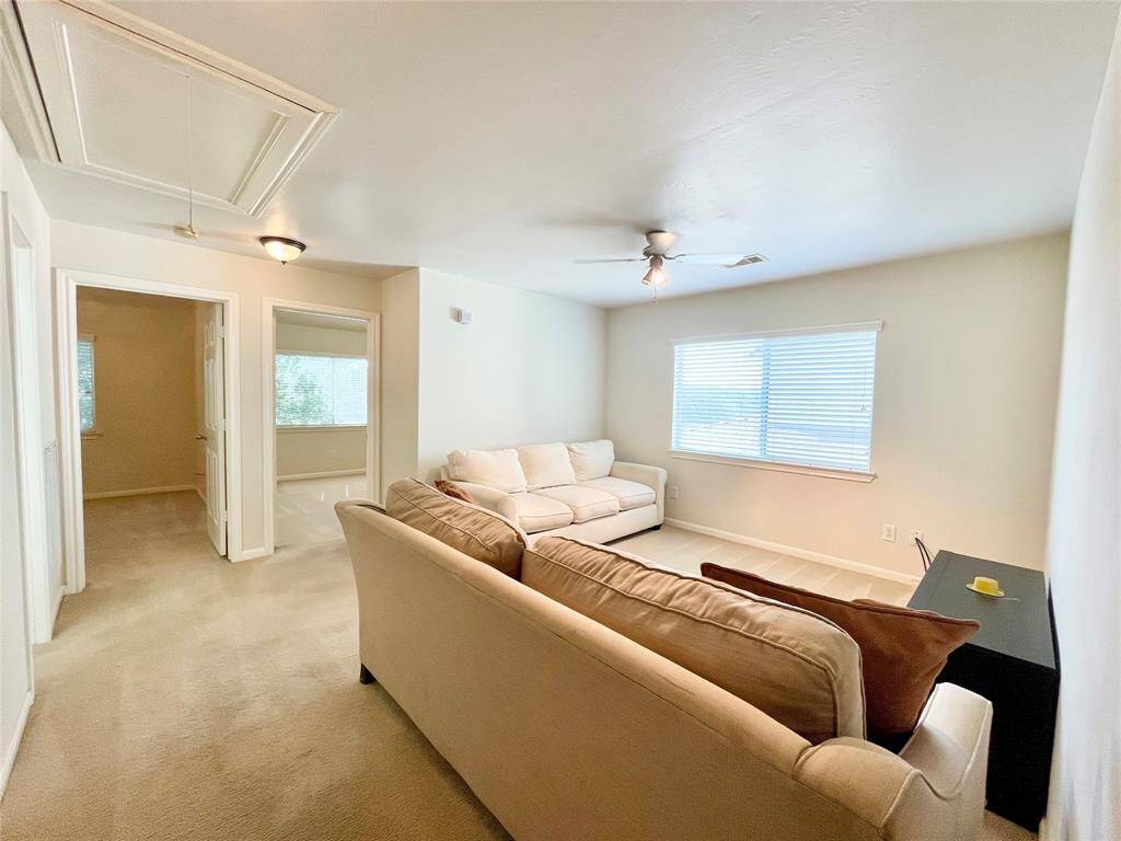 Cozy game room, carpeted living space with neutral walls.