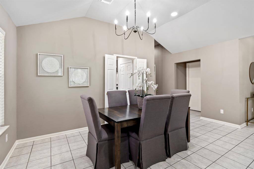 The formal dining space is conveniently located near the kitchen and features a set of double doors that can be closed for added privacy or opened for ease of service.
