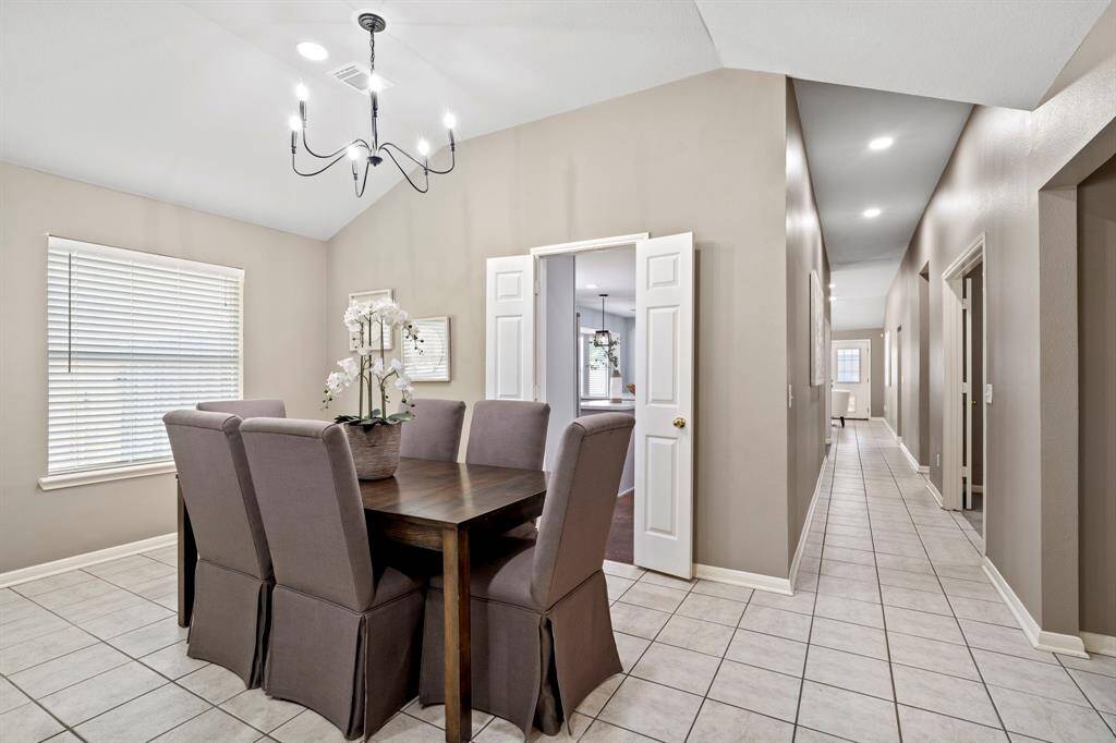 Just off the dining room, a long hallway provides access to the kitchen, bedrooms, and additional living areas, keeping the floor plan connected and functional.