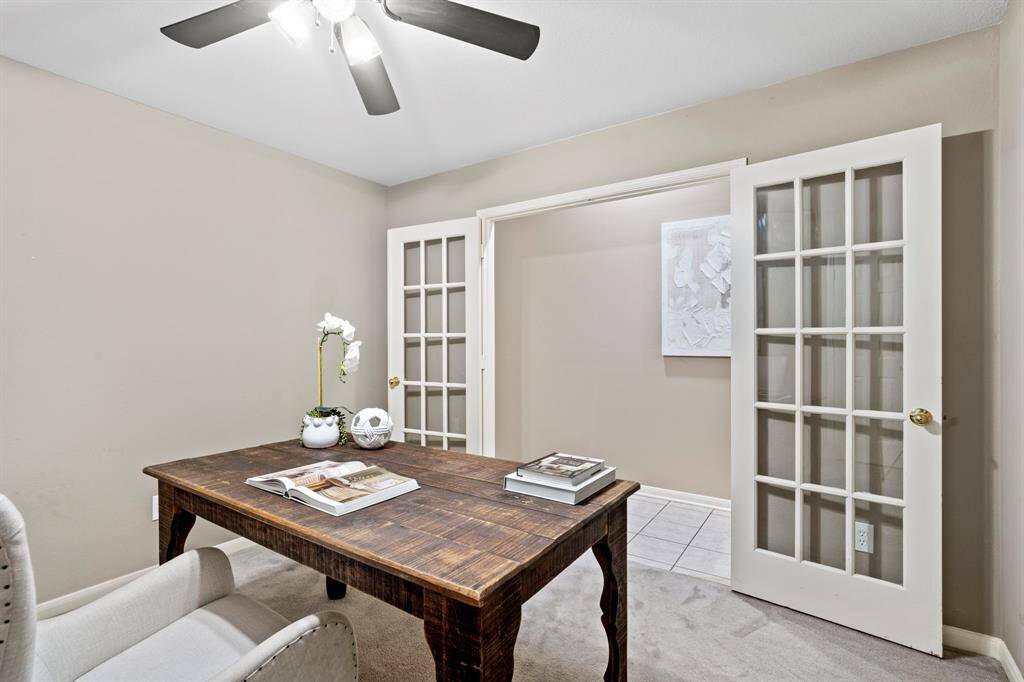 French doors open to reveal a peaceful workspace, ideal for remote work, creative projects, or managing household tasks.