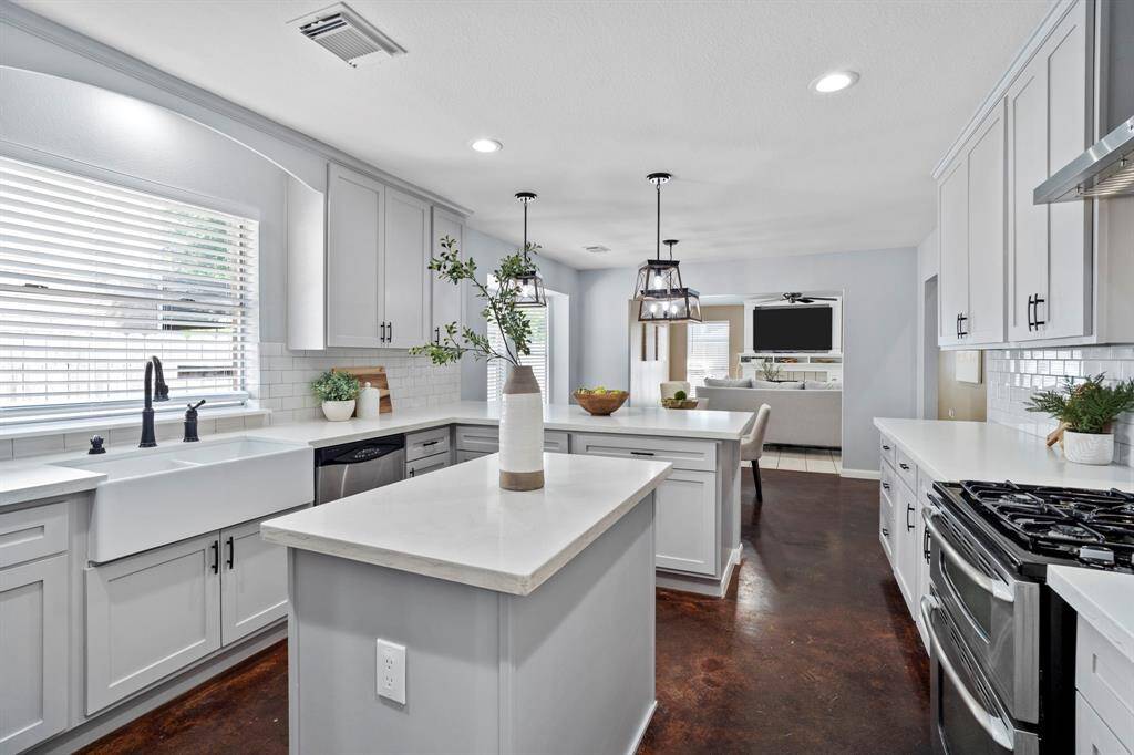 The kitchen opens seamlessly into the breakfast nook and family room, creating a natural flow for everyday living and effortless entertaining.