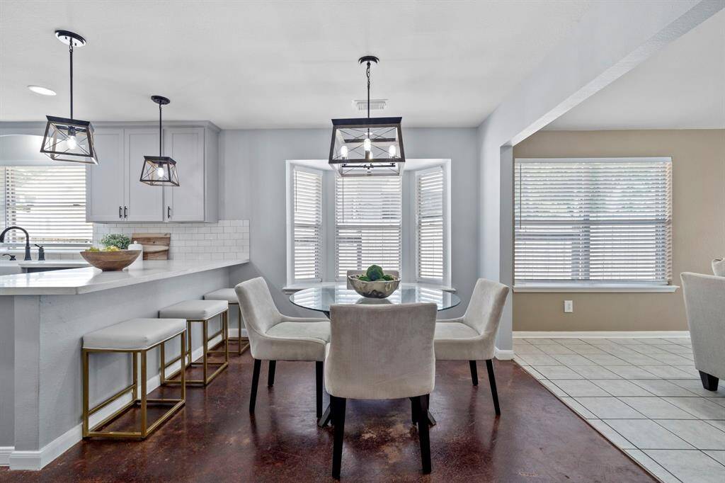 This light-filled breakfast area offers a perfect view of the beautifully updated kitchen, making morning routines feel effortless and elevated.