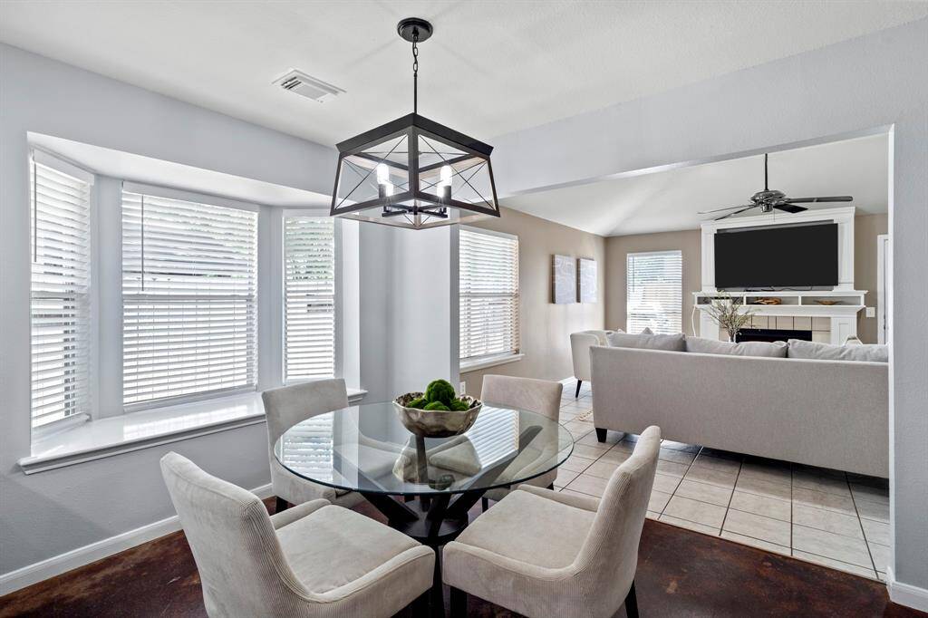 Tucked between the kitchen and family room, the breakfast area features a window seat, ample light, and easy access to both casual and formal living spaces.