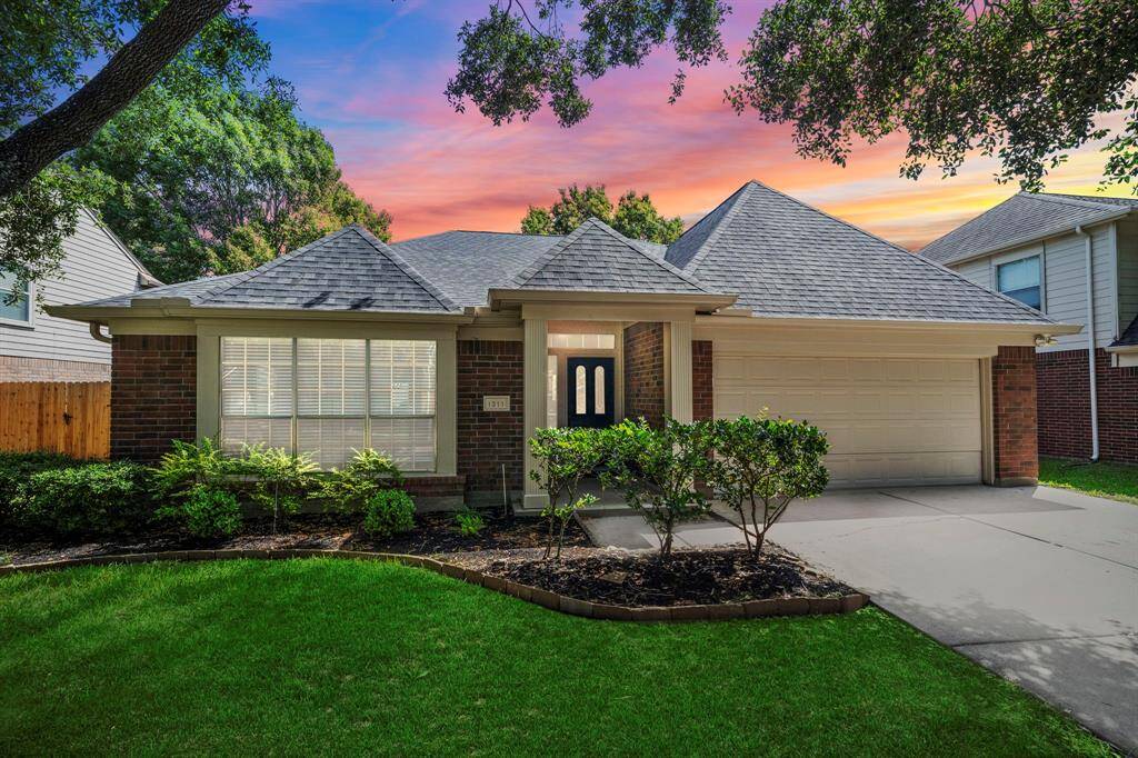 As the sun sets, this stunning home truly shines—highlighting the updated roof and gutters, charming architectural lines, and warm, inviting entry.