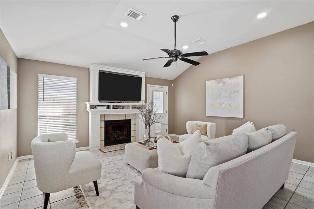 The cozy fireplace and built-in mantel create a welcoming focal point in this spacious family room with access to the backyard just steps away.
