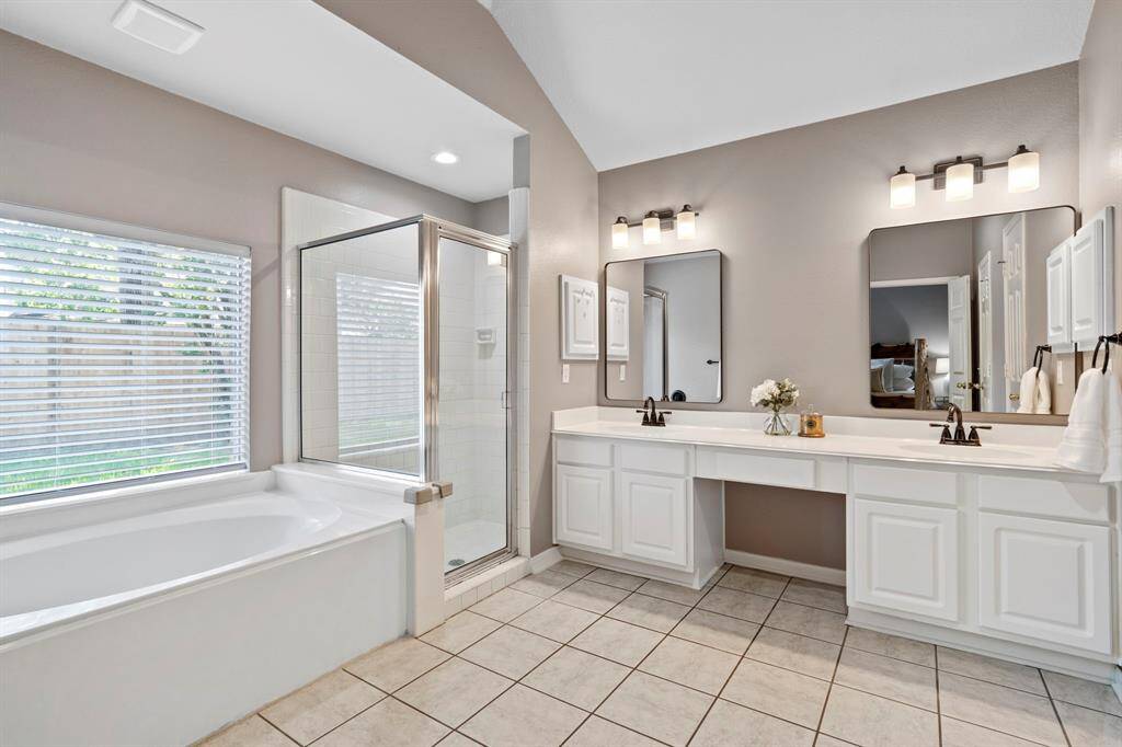 The Primary bathroom was thoughtfully designed for sharing, complete with dual sinks, and dual walk-in closets to accommodate the largest of wardrobes.