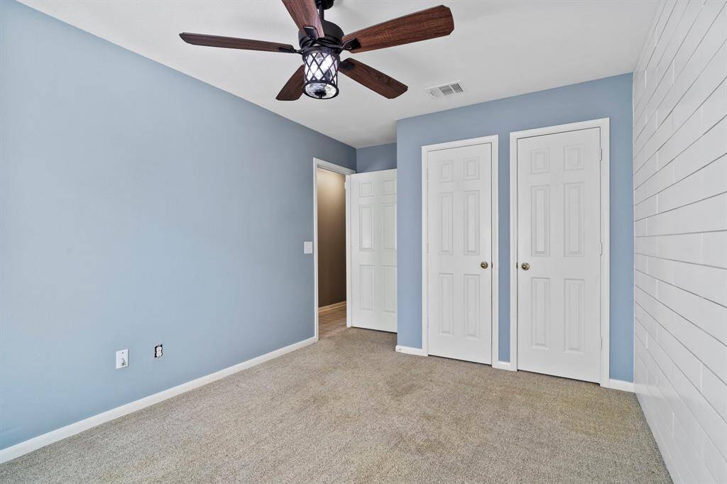 A soothing blue color palette and double door closet make this second bedroom as functional as it is stylish.