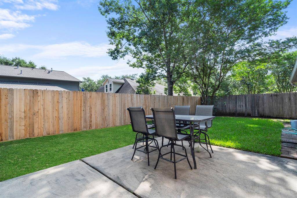 This spacious concrete patio offers the ideal setting for outdoor dining, entertaining guests, or simply relaxing after a long day.