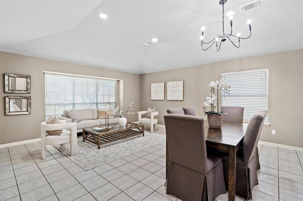 The formal dining room is anchored beneath a chic chandelier and offers plenty of room for hosting everything from holiday dinners to casual meals.