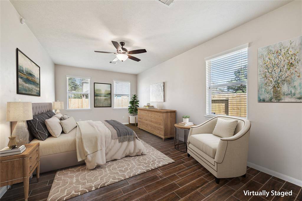 Spacious, bright & inviting primary bedroom filled with natural light.