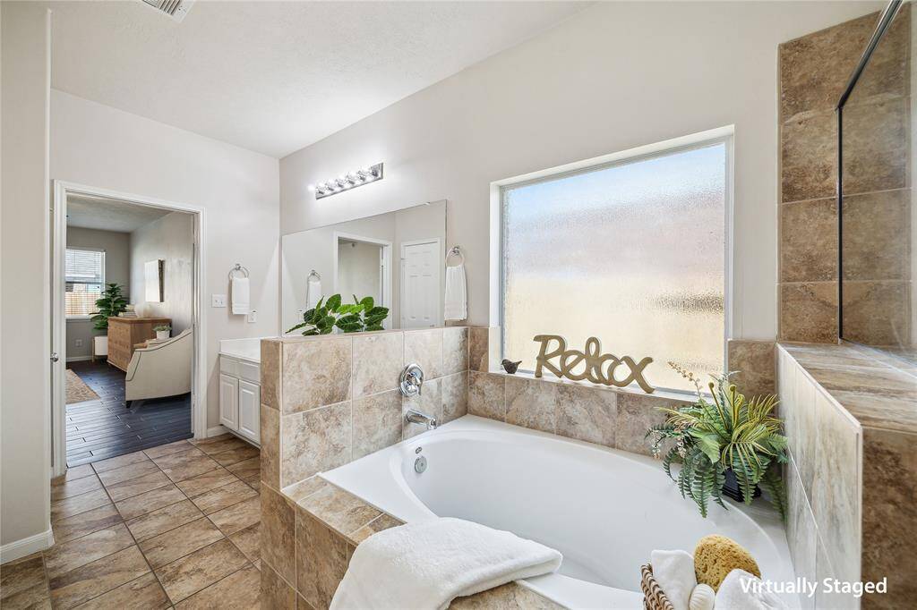 Alternate view of primary ensuite bathroom with soaking tub.