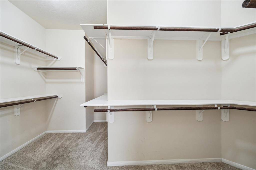 Expansive walk-in closet in the primary bedroom offers ample storage and organization.