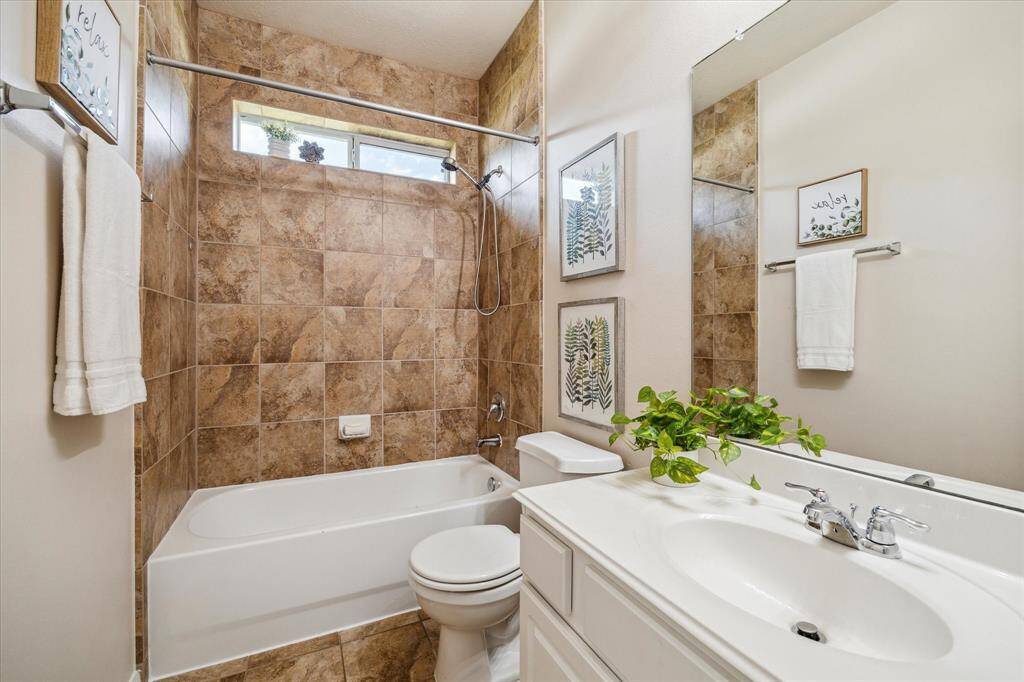 This full bathroom conveniently serves the secondary bedrooms.