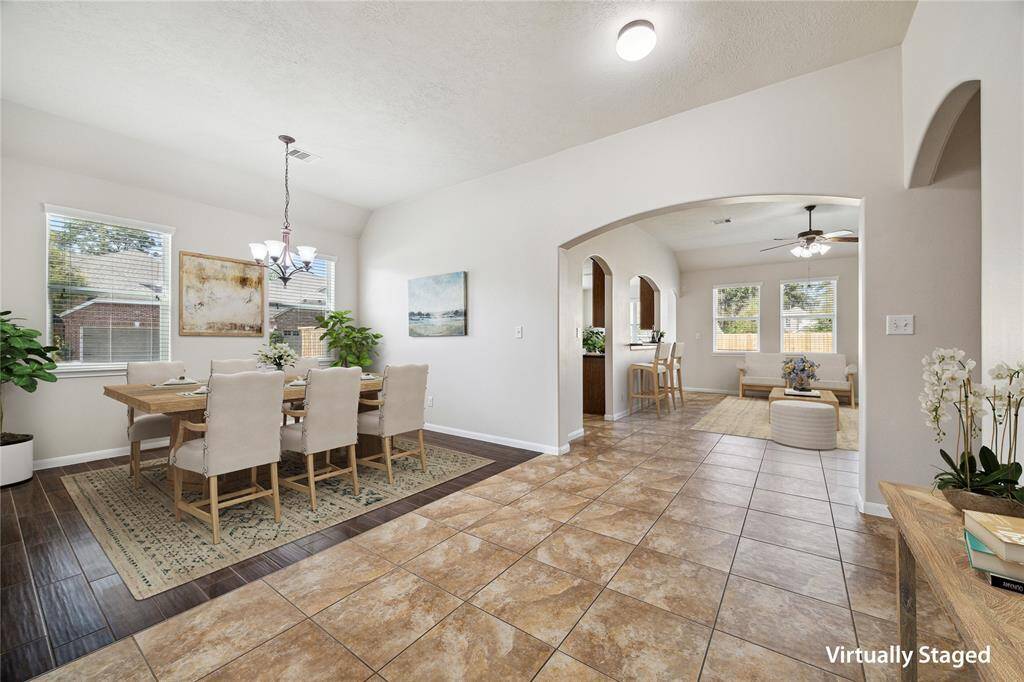 Elegant dining room with natural light, perfect for gatherings and creating memorable meals.