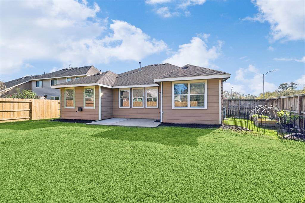 Enjoy the spacious, fully fenced backyard with a cozy patio and a charming side garden.