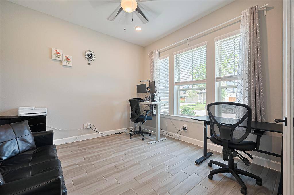 The dedicated office/study offers a quiet workspace with large windows that flood the room with natural light