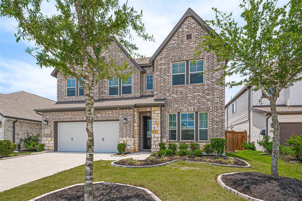 Two-car garage and manicured land scaping on a spacious lot