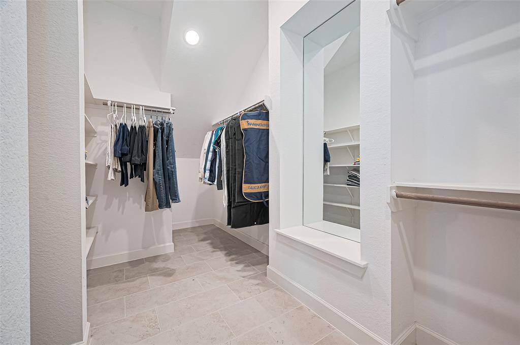 The expansive walk-in closet - thoughtfully designed for both style and function, it provides plenty of space to organize wardrobes, accessories, and more with ease