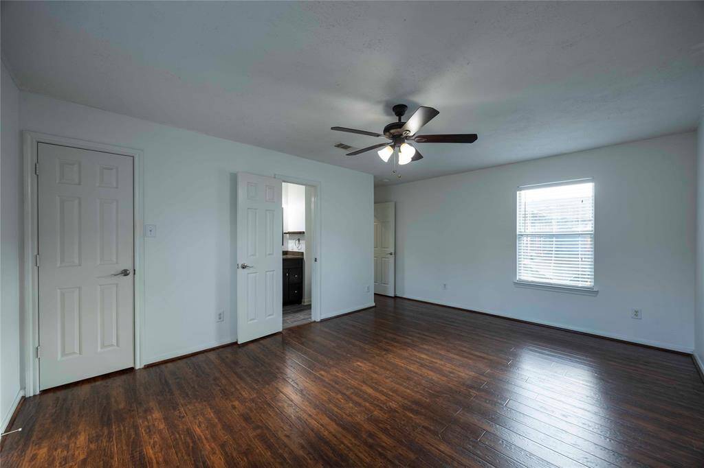 Primary bedroom view to closet/bath/hallway