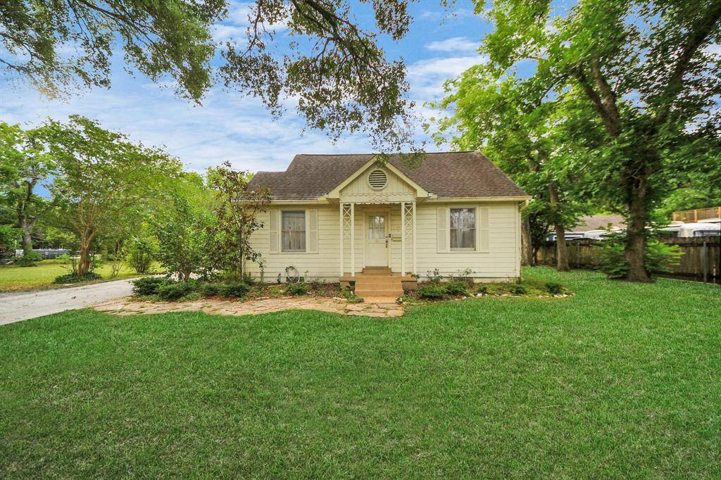 Welcome to this timeless Old Rosenberg treasure, set back on a spacious front lawn with charming curb appeal. A sunny yellow exterior and columned front porch invite you in with classic warmth and small-town charm.