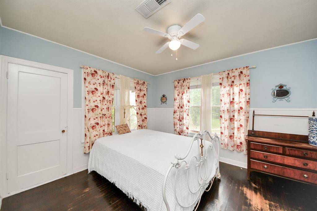 The second bedroom features classic windows that brighten the room and a door that leads directly to the bright sunroom.