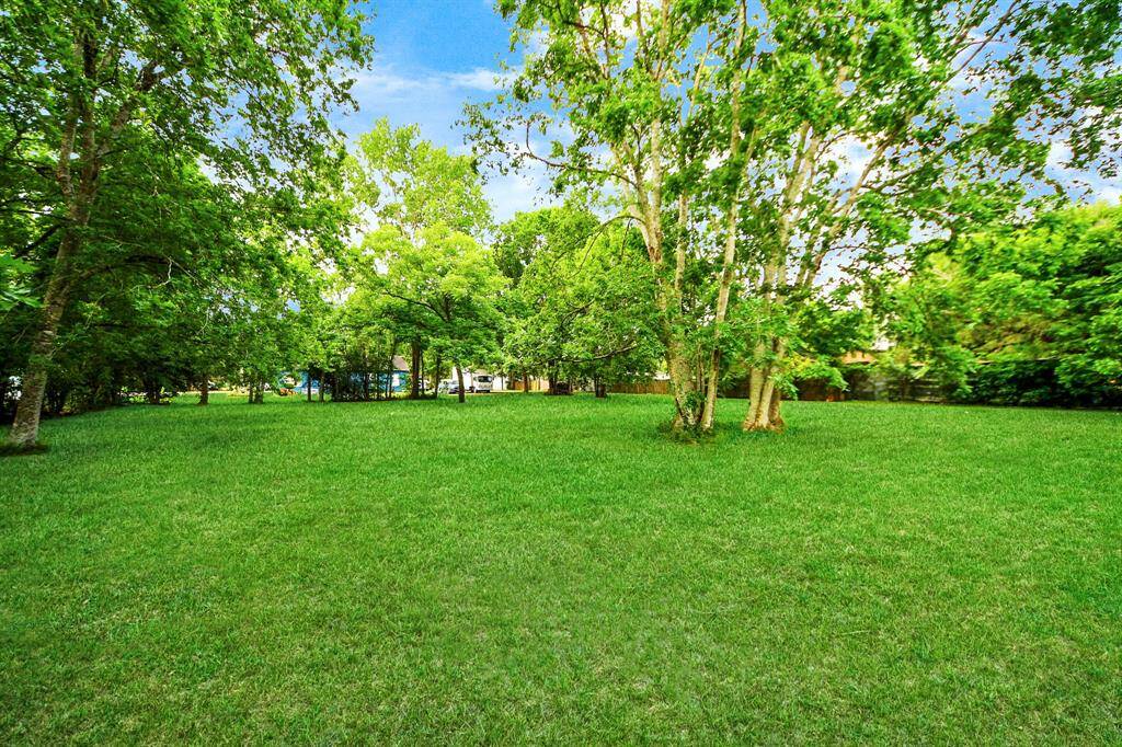 Trees and landscaping line the backyard, creating a natural privacy barrier for your outdoor haven.