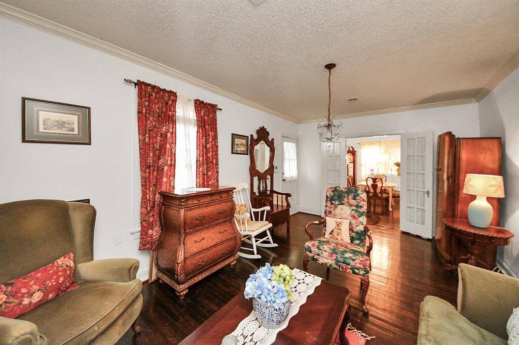 Just off the den is the formal dining room which features elegant French doors, allowing you to create an open flow or a cozy, separated space. It is perfect for both intimate dinners and lively gatherings, blending flexibility with architectural appeal.