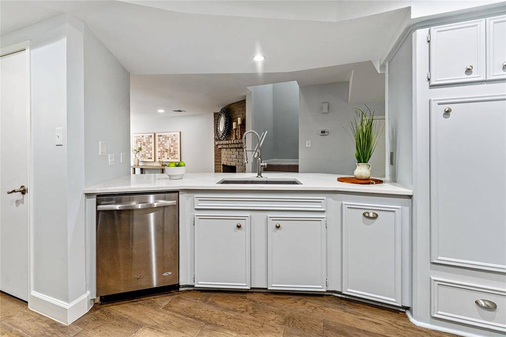 Another view of the well-lit kitchen, with plentu of storage space.