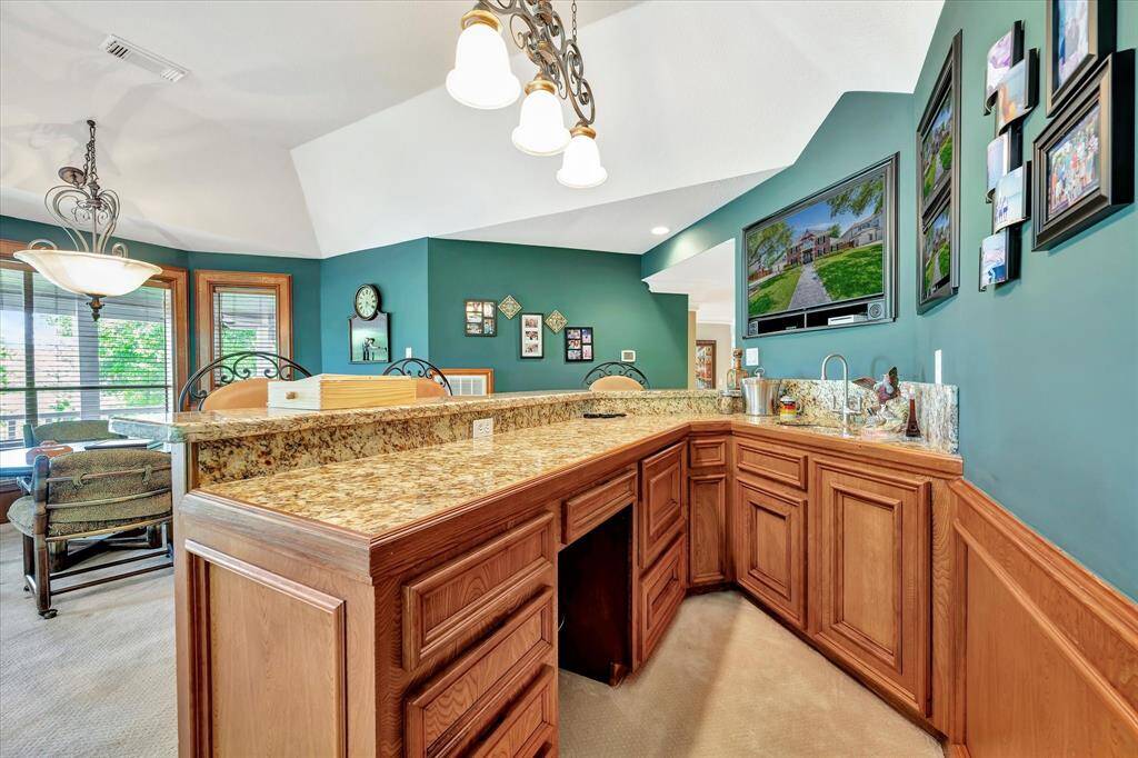 This spacious game room features a pool table, ample natural light from large windows, and a cozy seating , ideal for what your family chooses. Grand versatility.