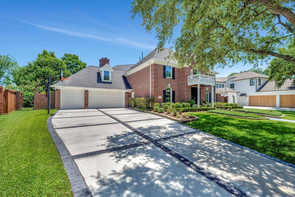 Double wide driveway with fresh concrete leads to 3 car garage with over 800 square feet. Door on side leads through laundry room to kitchen.